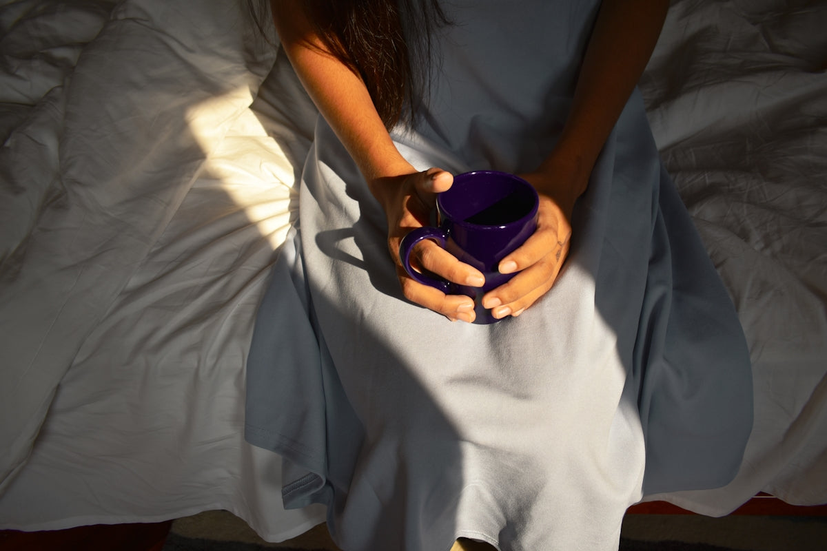 woman in white dress holding purple ball