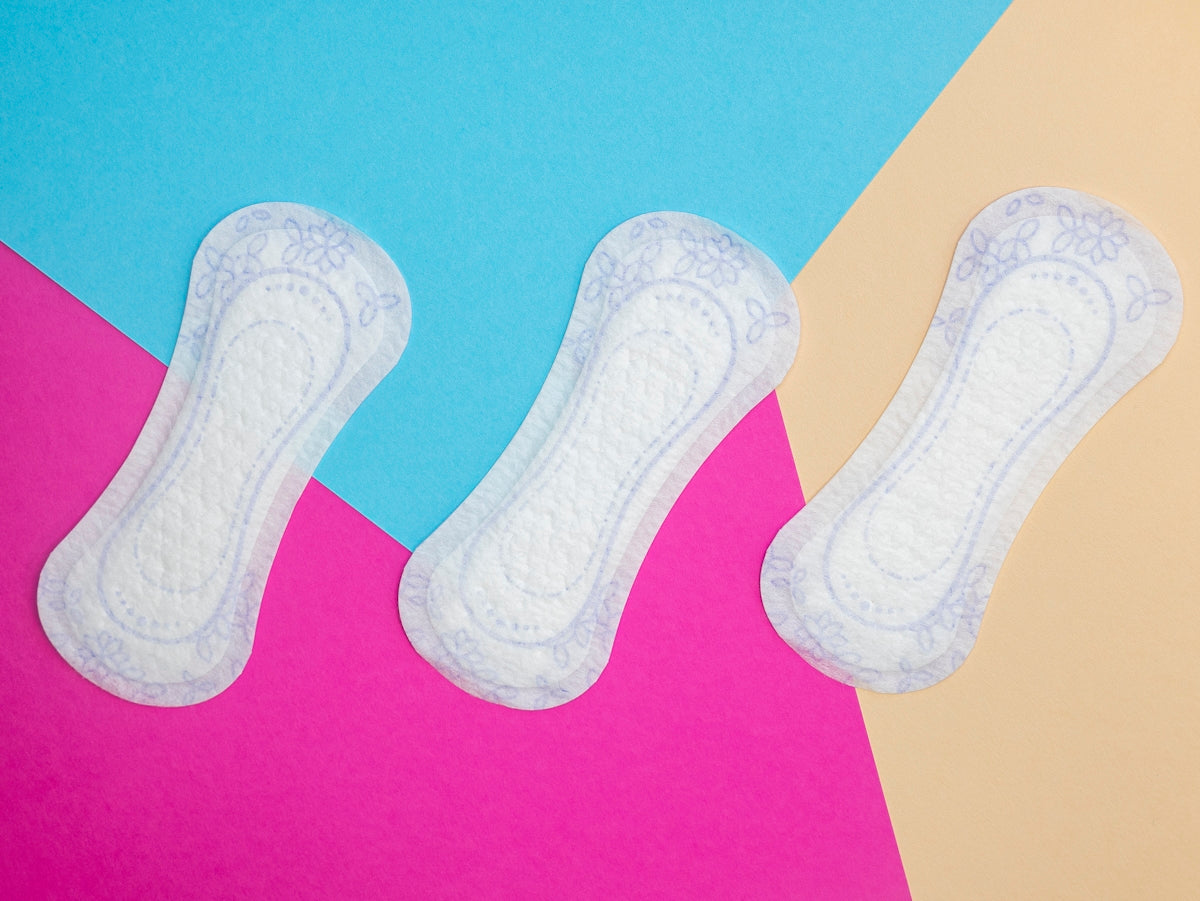 a pair of white socks sitting on top of a pink and blue background