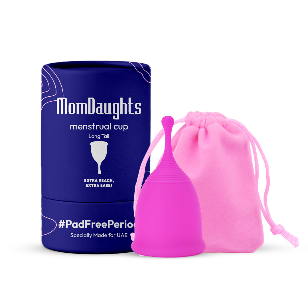 Front view of MomDaughts' Long Tail Menstrual Cup in pink color with cotton bag