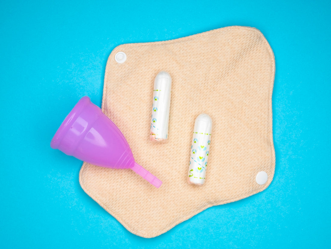 two toothbrushes and a purple cup on a blue background