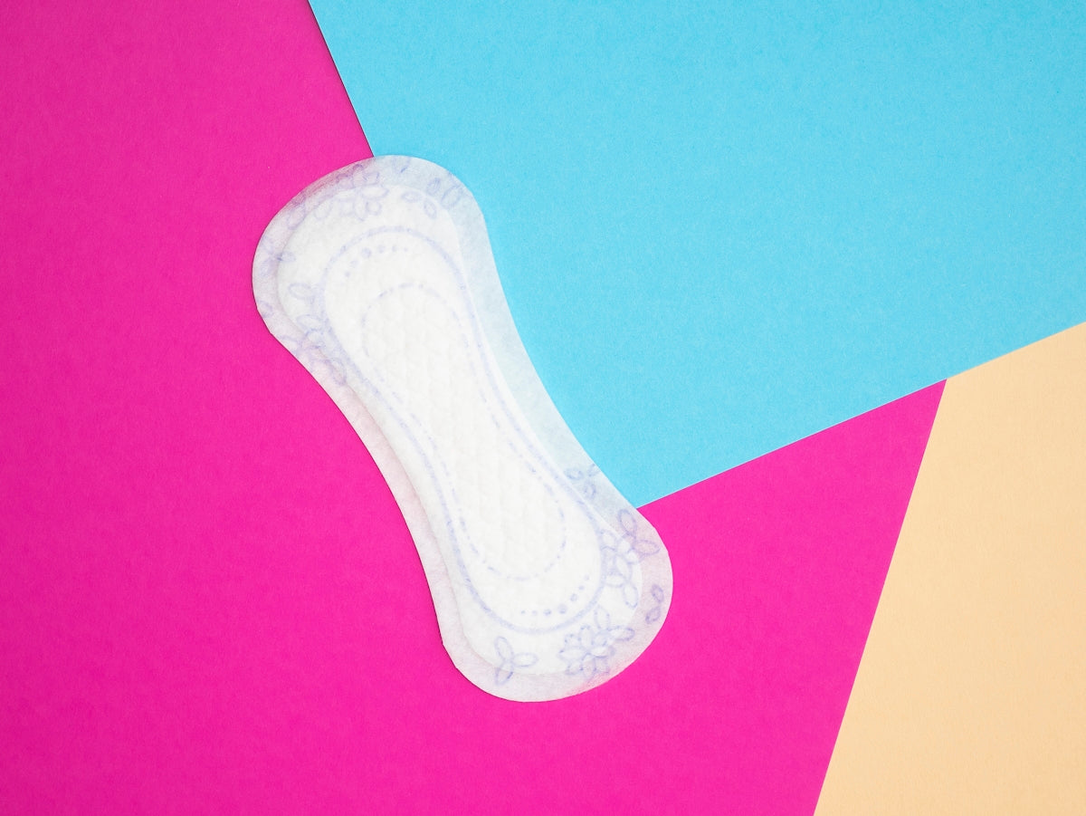 a pair of white socks sitting on top of a pink and blue background