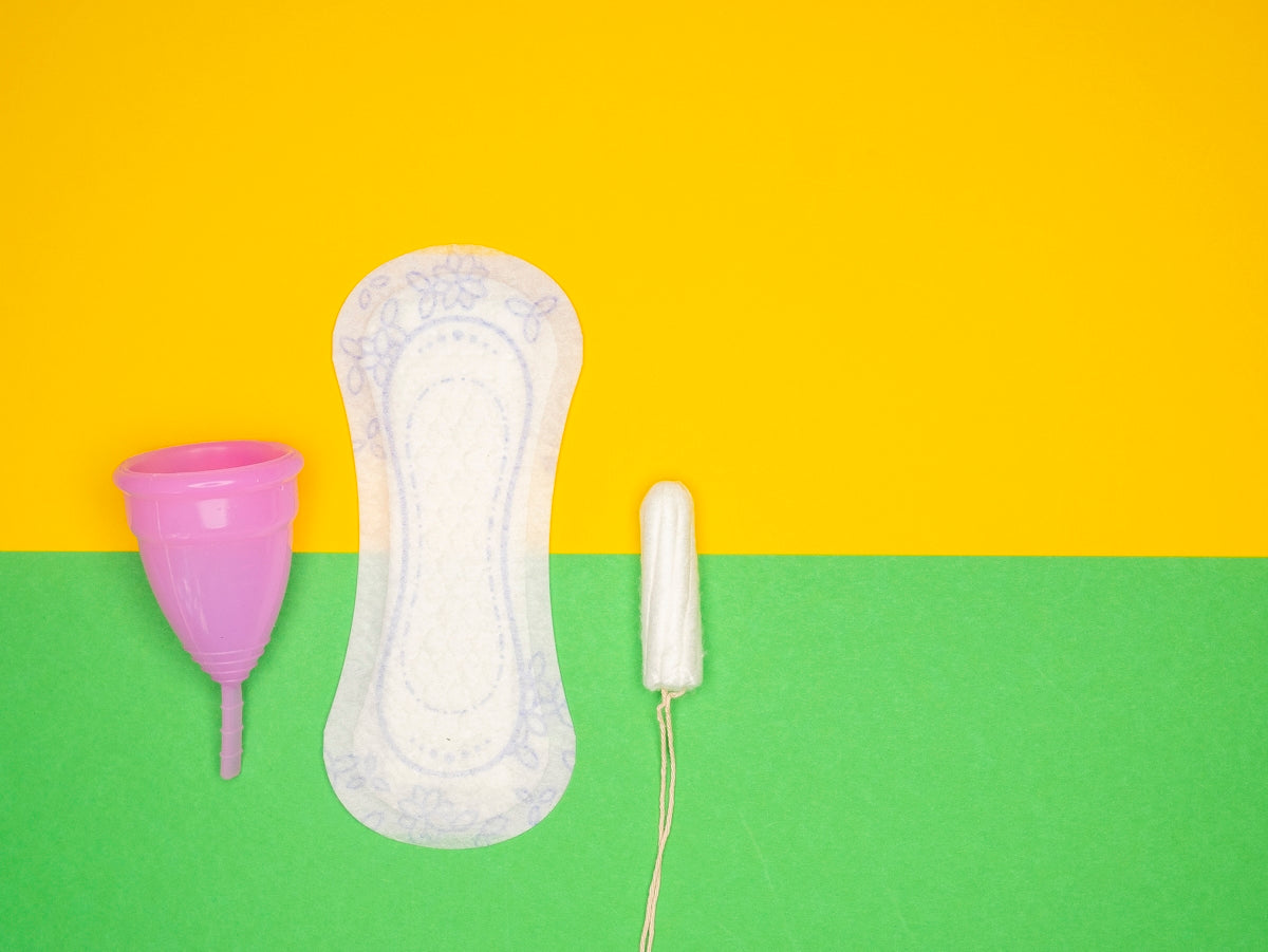 a hairdryer and a pair of shoes on a green and yellow background